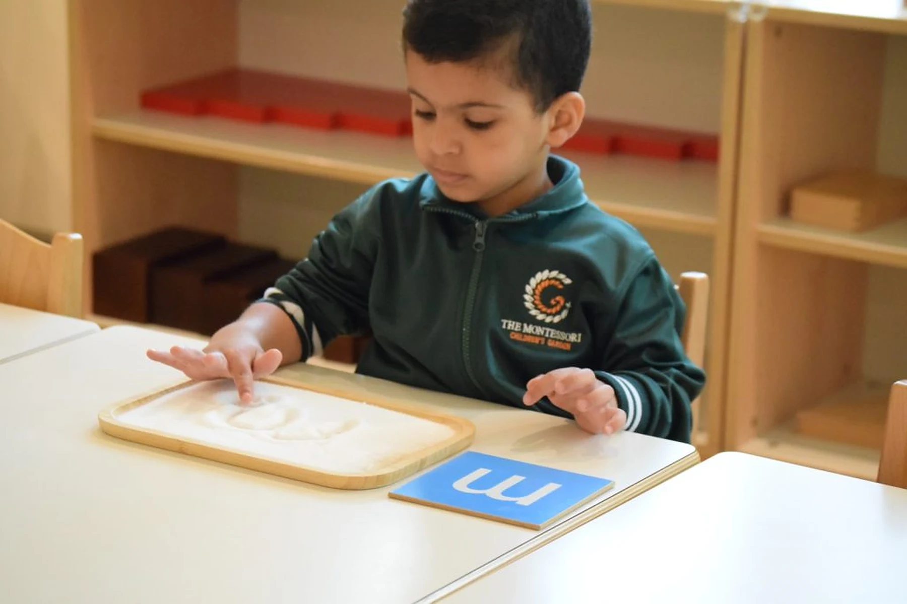 A TMCG child working independently with Montessori materials in the nursery classroom