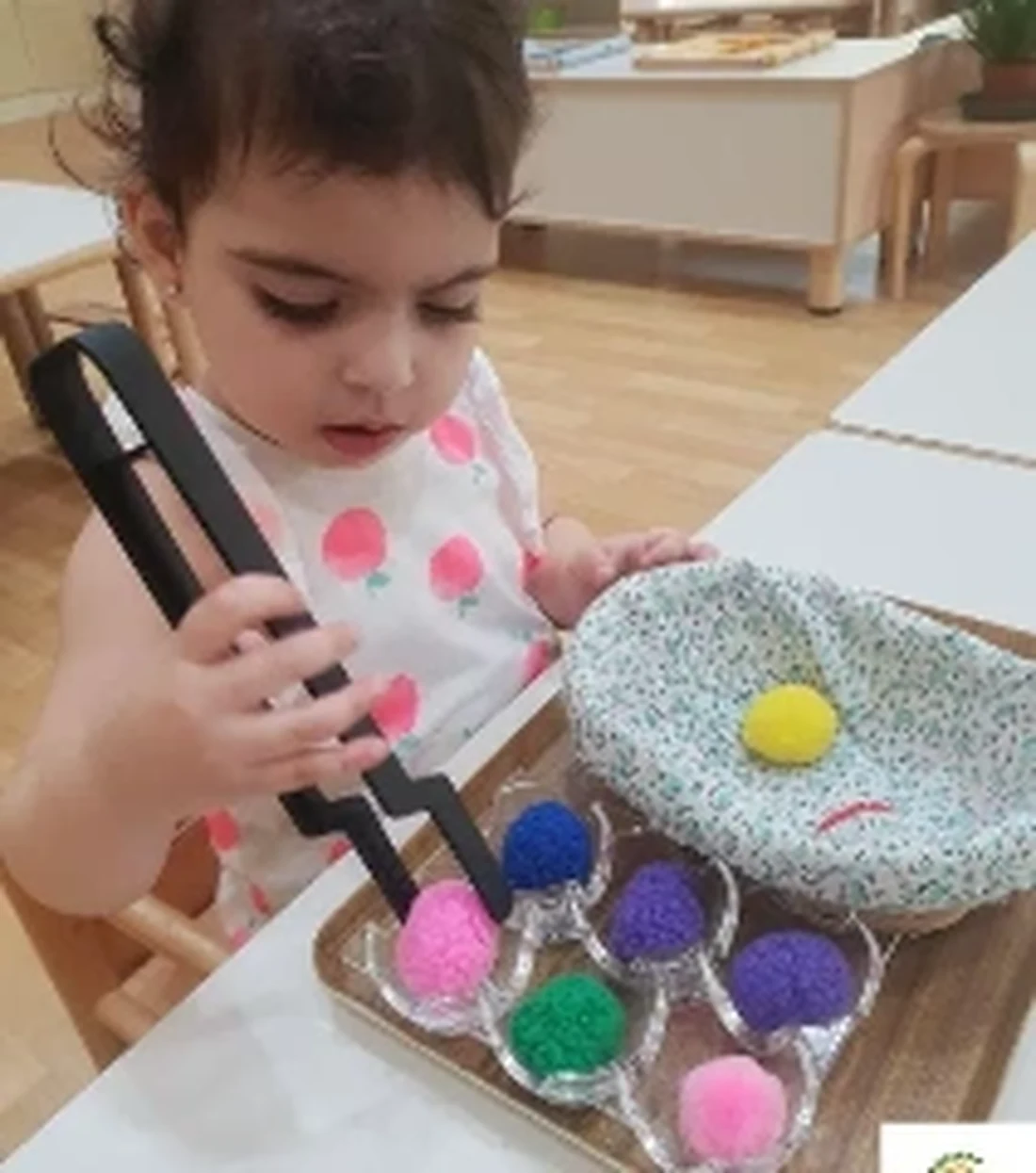A TMCG child exploring a colourful sensory activity